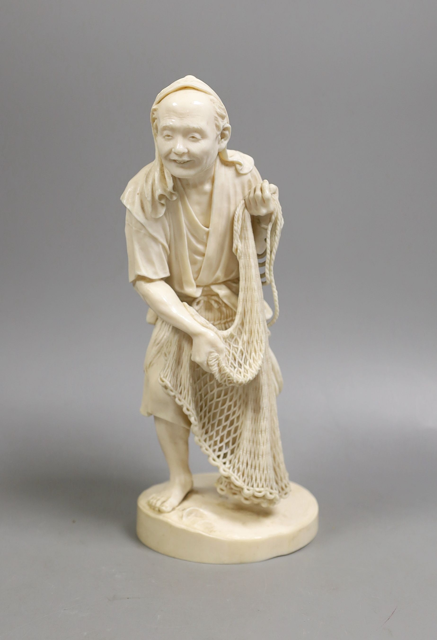 A large Japanese Tokyo School ivory figure of a fisherman, signed, Meiji period, 26 cms high.